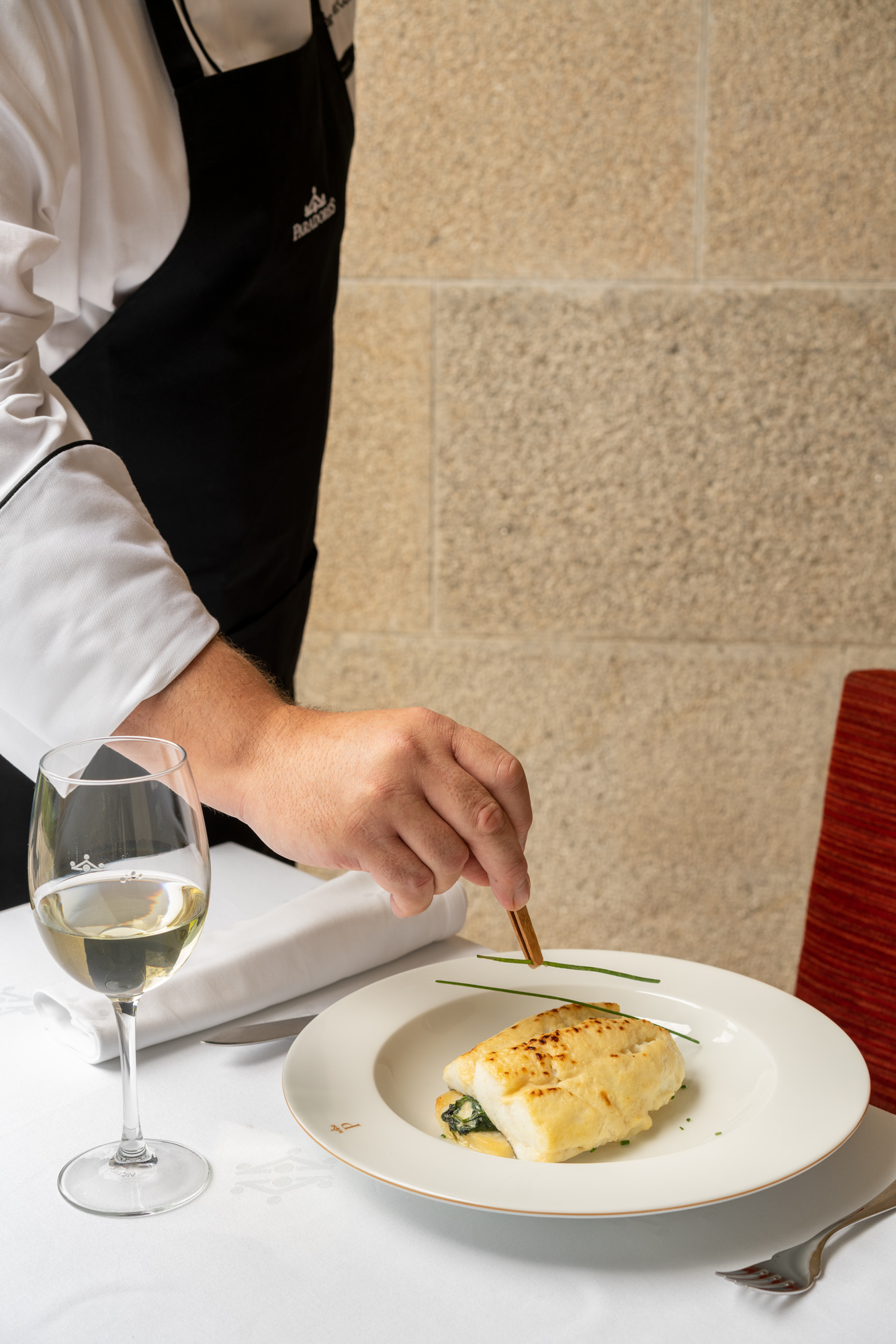 Desayuno preparado en mesa exterior con vista a prados verdes con las montañas de Verín al fondo