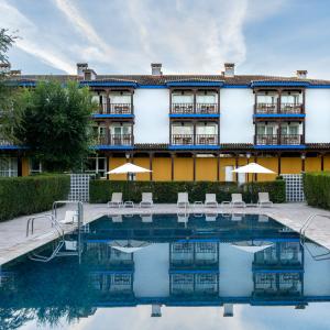 Parador de Manzanares de fondo en la piscina